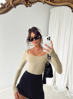 side view of model wearing Princess Polly Mallard Bodysuit Brown Petite Full Sleeves 
