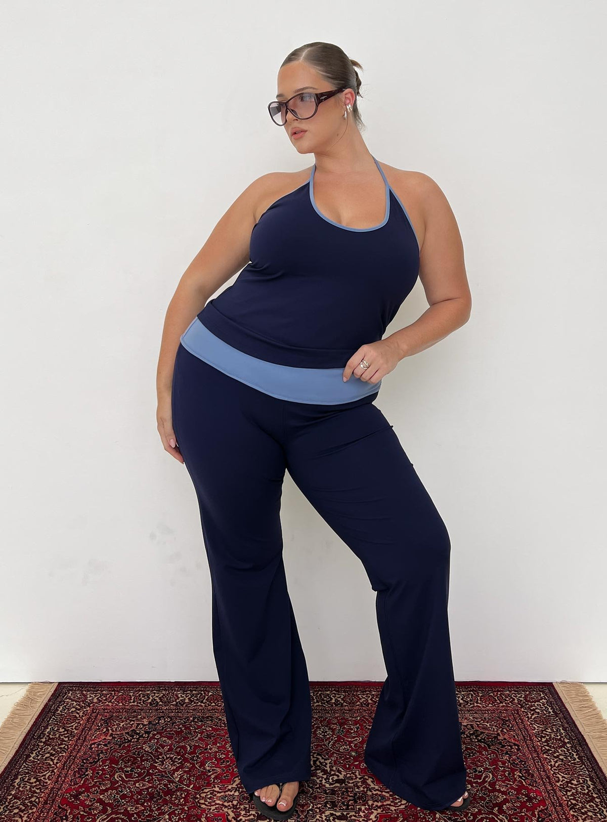 front view of model wearing Princess Polly Kobee Jersey Flare Pants Navy / Light Blue Curve High Rise Pants 