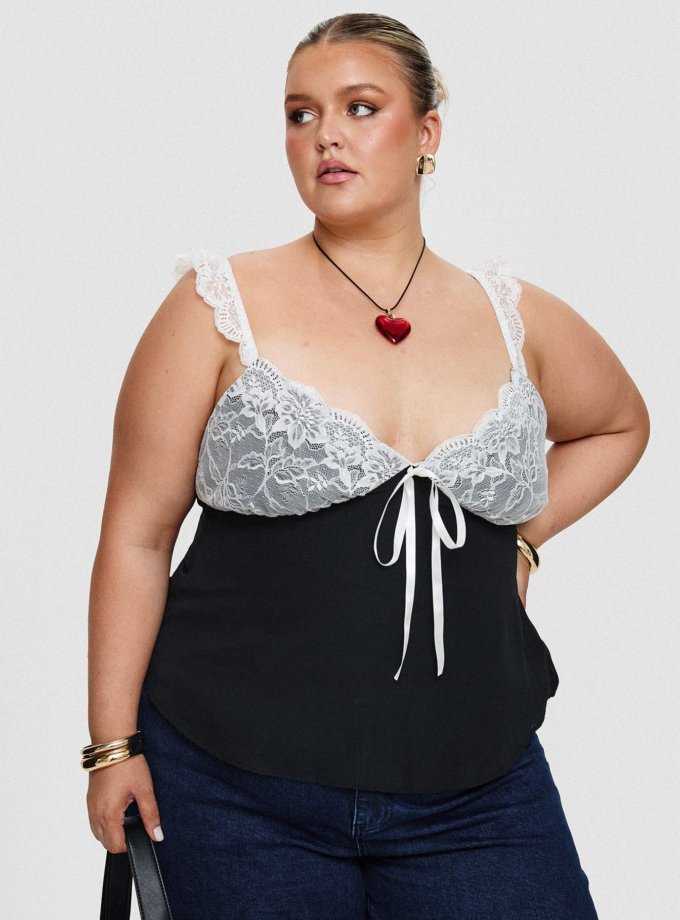 side view of model wearing Princess Polly Delvonte Top Black Curve Sleeveless Plunger 