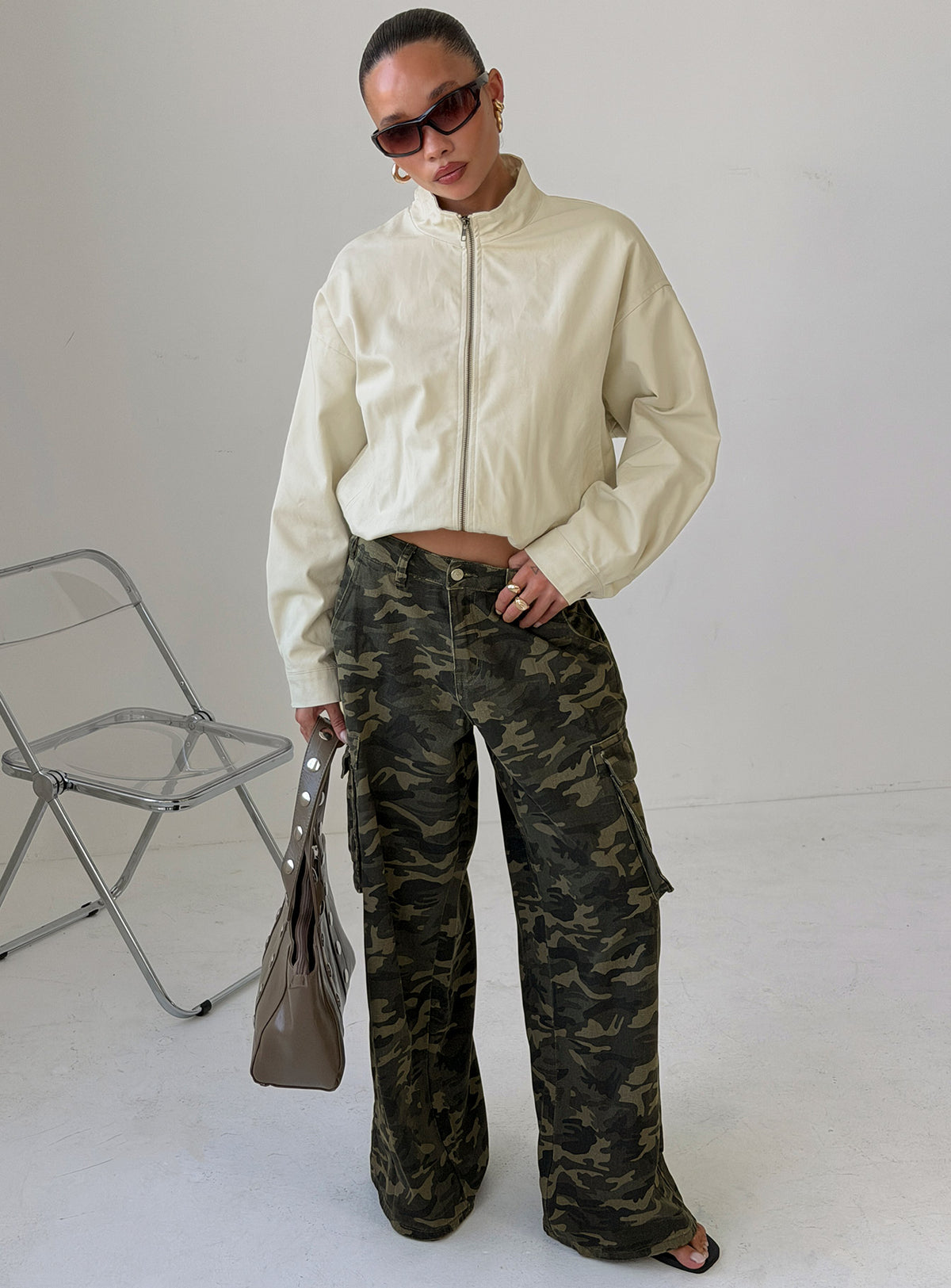 Showcasing Hudsen Cargo Pants Camo in womens regular pants with mid-rise waist and camo print front view of model wearing Princess Polly