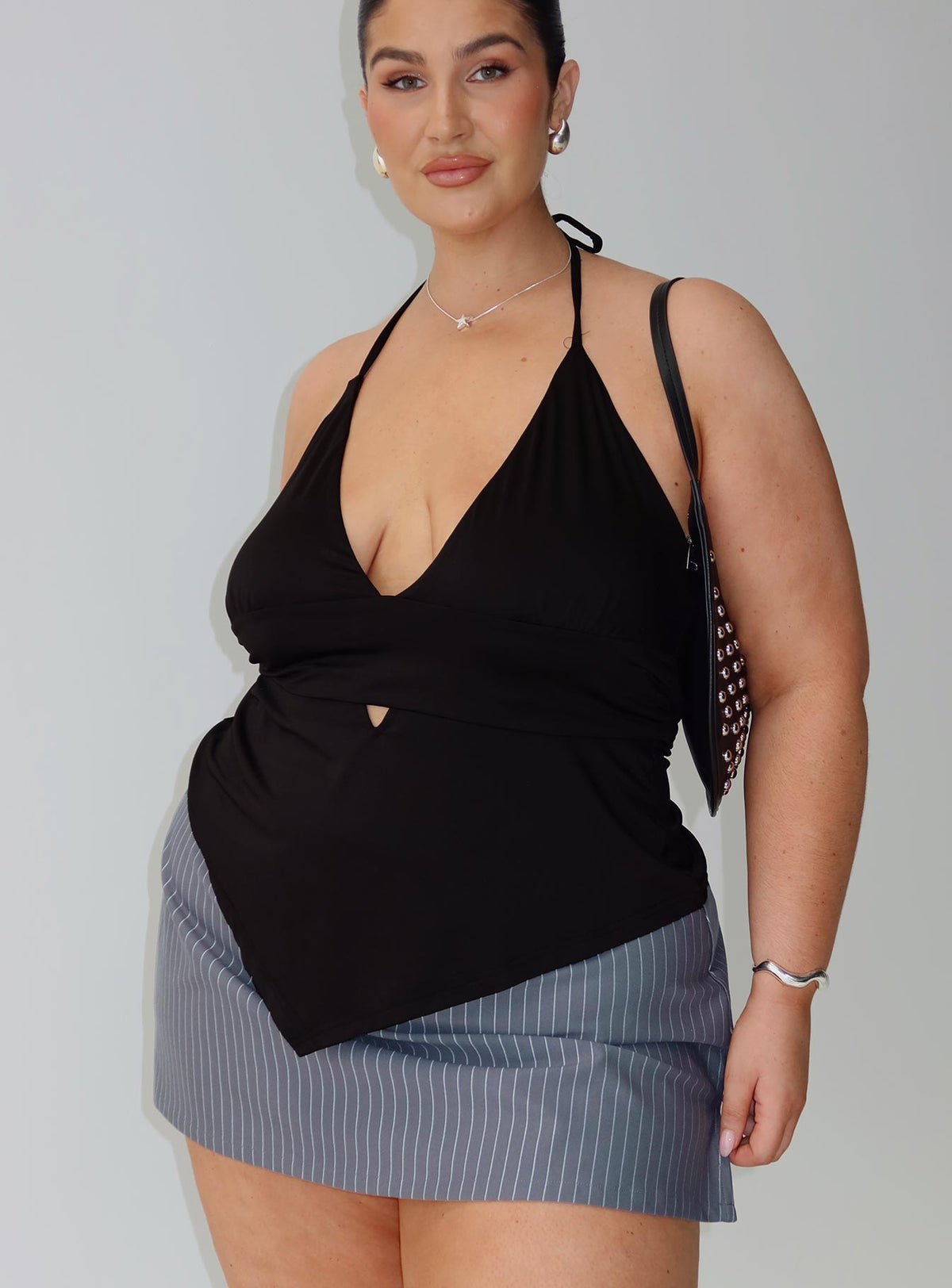side view of model wearing Princess Polly Averee Halter Top Black Curve Sleeveless Plunger 