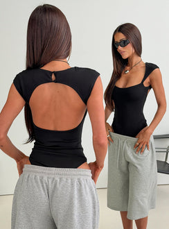 Designed with the Fabienna Scoop Neck Cap Sleeve Bodysuit in black featuring short sleeves back view of model wearing Princess Polly