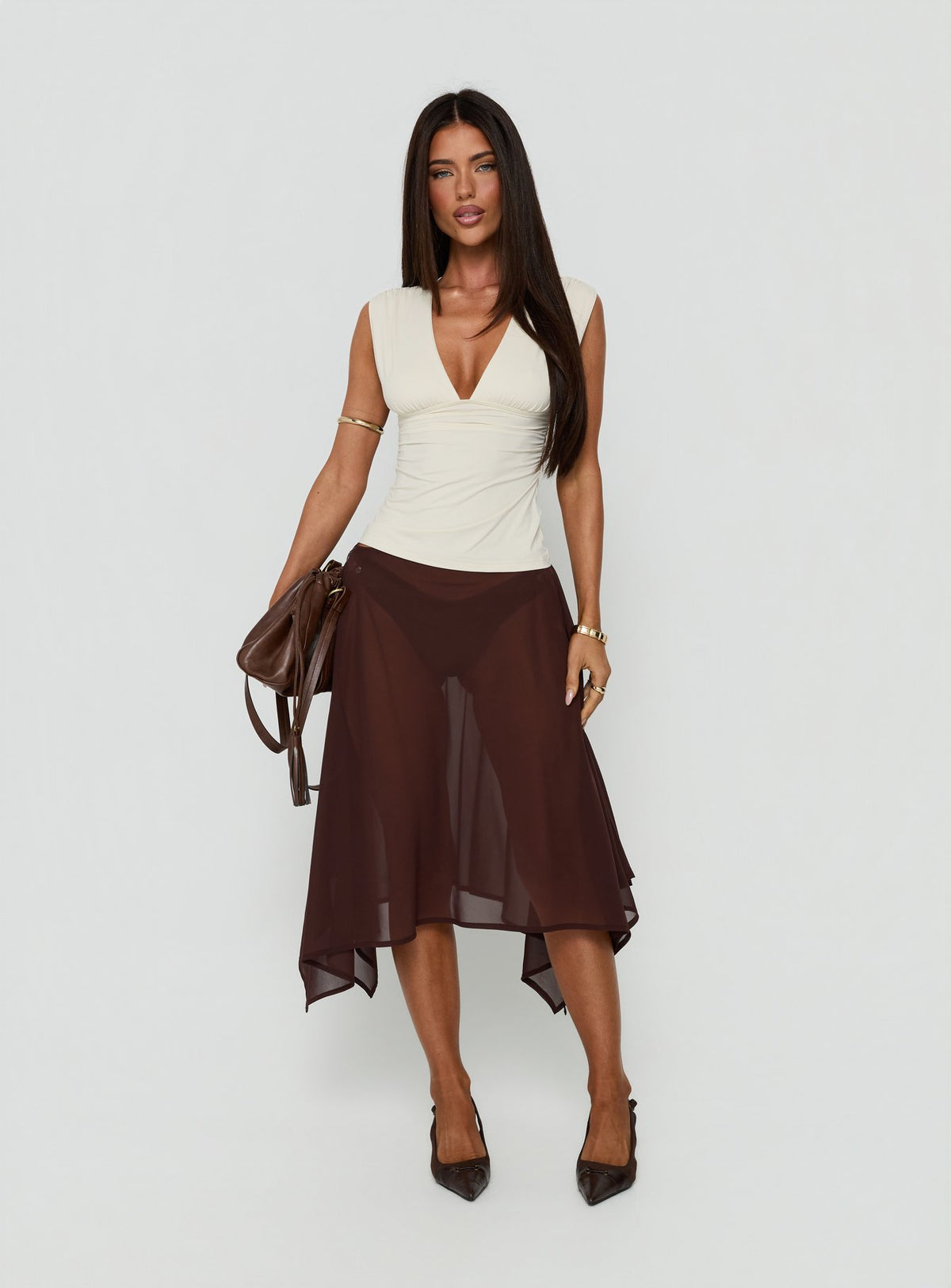 Featuring the Asali Asymmetrical Midi Skirt Chocolate womens-skirts in midi length front view of model wearing Princess Polly
