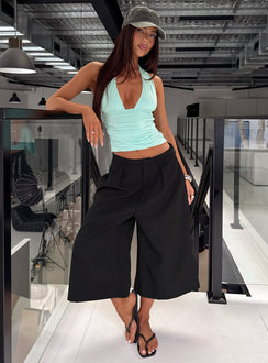 Showcasing the Busy Busy Low Baggy Capri Pant Black in womens-regular-pants with low-rise front view of model wearing Princess Polly
