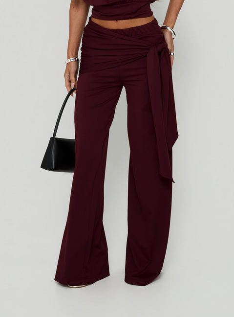 Featuring the Hadlia Tie Waist Pants Burgundy womens-regular-pants with high-rise detail front view of model wearing