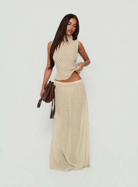 Introducing the Ford Maxi Skirt Butter Chocolate Polka Dot in womens-skirts, featuring a maxi length silhouette front view of model wearing Princess Polly