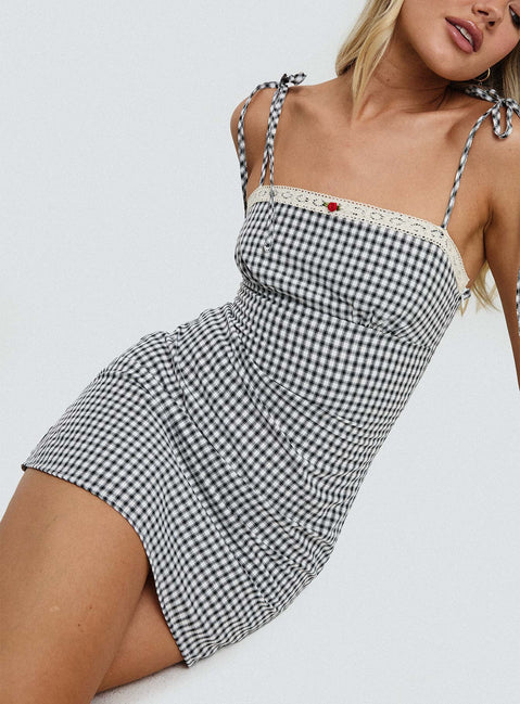 side view of model wearing Princess Polly Burkes Mini Dress Black Check Square Neck 