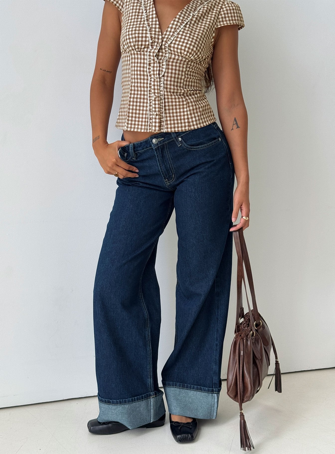 front view of model wearing Princess Polly Darla Low Rise Straight Leg Cuff Jean Dark Blue Wash Low Rise Jeans 