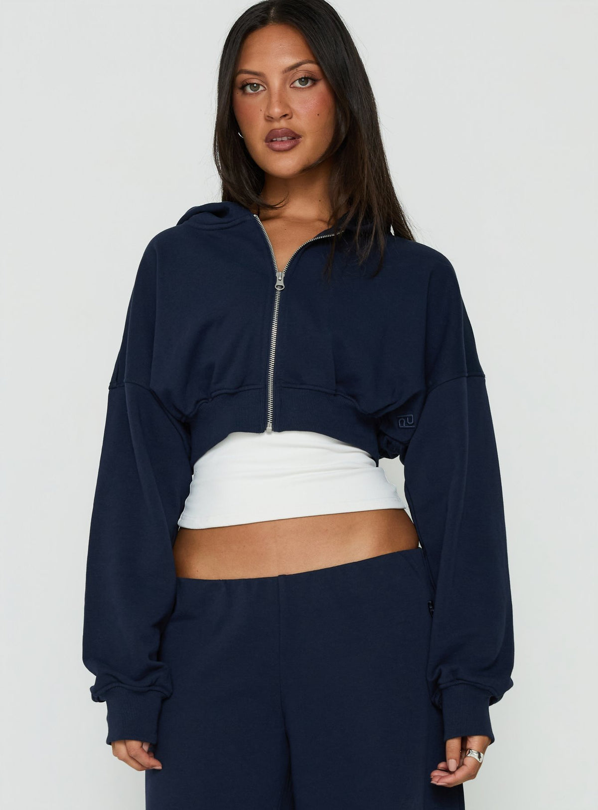 Showcasing the Lanna Fleece Zip Through Cropped Hoodie Navy womens-jumpers with short length front view of model wearing Princess Polly