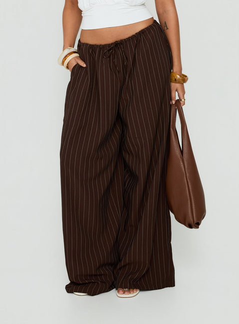 Showcasing the Bungala Oversized Relaxed Pants Brown Pinstripe womens-regular-pants with mid-rise front view of model wearing Princess Polly