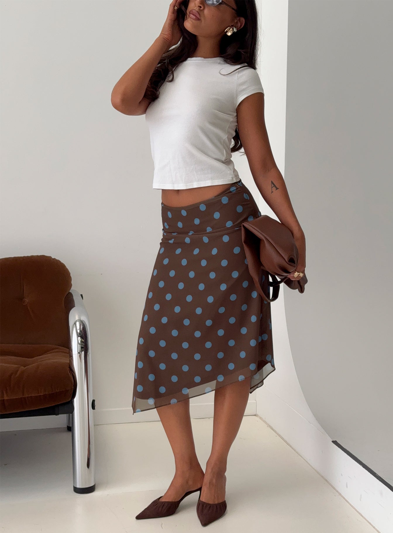   side view of model wearing Princess Polly Daphene Asymmetrical Midi Skirt Brown / Blue Polka Dot Midi Skirts 
