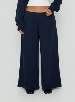 Showcasing the Kaeya Fleece Wide Leg Low Rise Pants Navy in womens regular pants with low-rise front view of model wearing Princess Polly