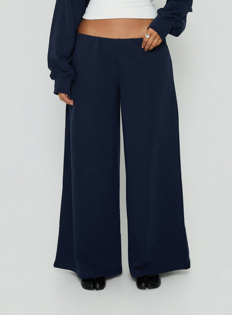 Showcasing the Kaeya Fleece Wide Leg Low Rise Pants Navy in womens regular pants with low-rise front view of model wearing Princess Polly