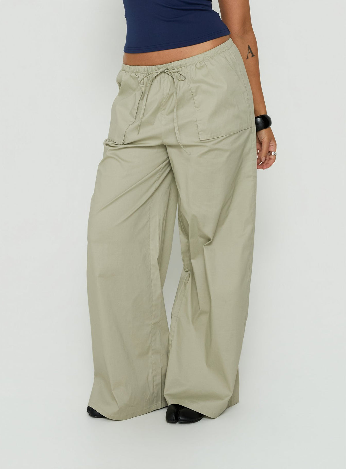 Showcasing Toren Drawstring Straight Leg Pants Stone womens-regular-pants with mid-rise front view of model wearing Princess Polly