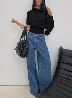 side view of model wearing Princess Polly Naylor Mid Rise Wide Leg Jeans Mid Blue Wash Mid Rise Jeans 