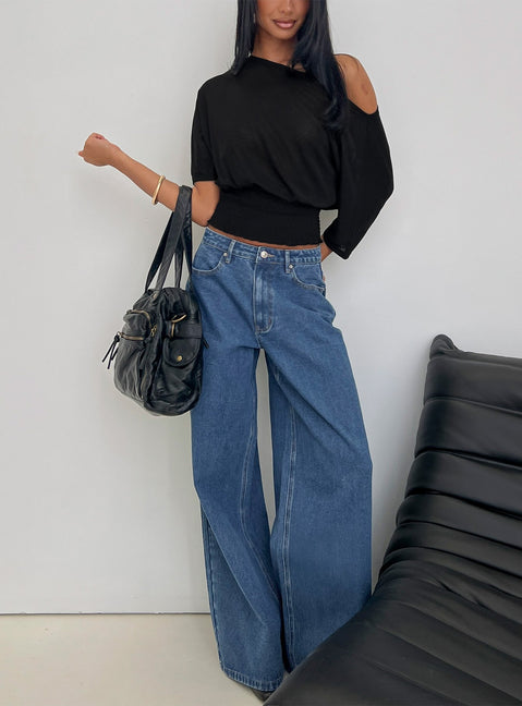 side view of model wearing Princess Polly Naylor Mid Rise Wide Leg Jeans Mid Blue Wash Mid Rise Jeans 