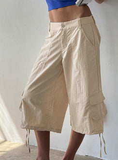 Showcasing the Relaxer 3/4 Cargo Pants Beige in womens regular pants with mid-rise side view of model wearing Princess Polly