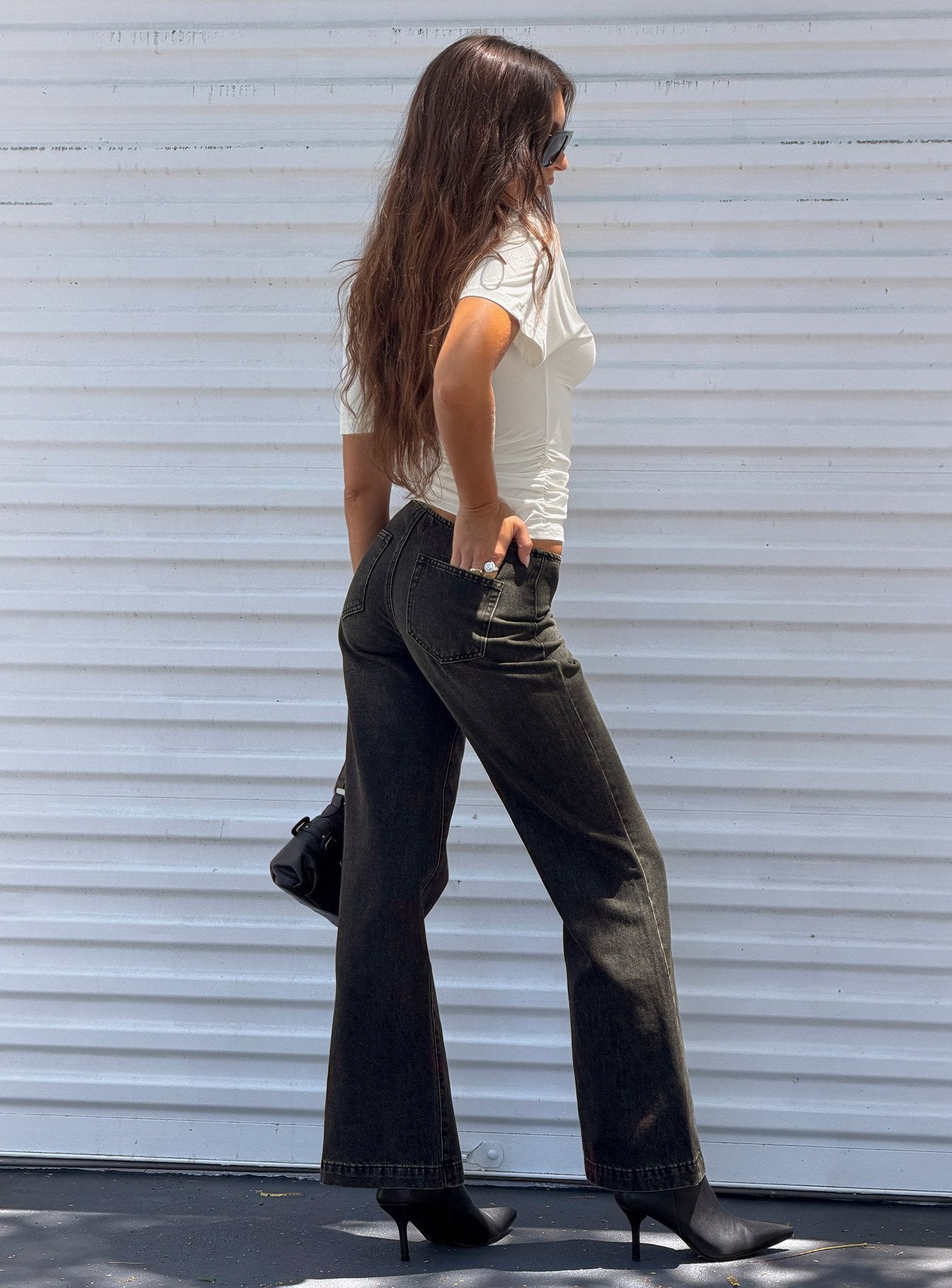 Featuring Buenos No Waist Low Rise Straight Leg Jeans in Washed Black womens-jeans with low-rise side view of model wearing Princess Polly