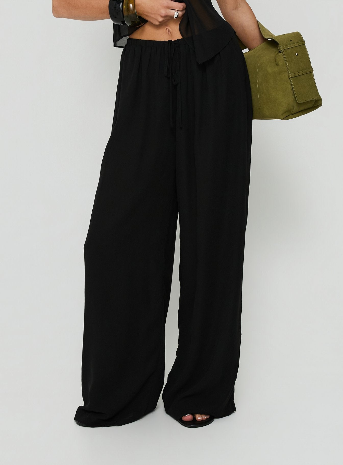 Featuring the Finesse Pants Black in womens-regular-pants with mid-rise wide-leg silhouette front view of model wearing Princess Polly