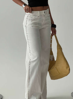 Showcasing the Saving Up Mid Rise Straight Leg Studded Jeans White in womens-jeans with silver studs side view of model wearing Princess Polly