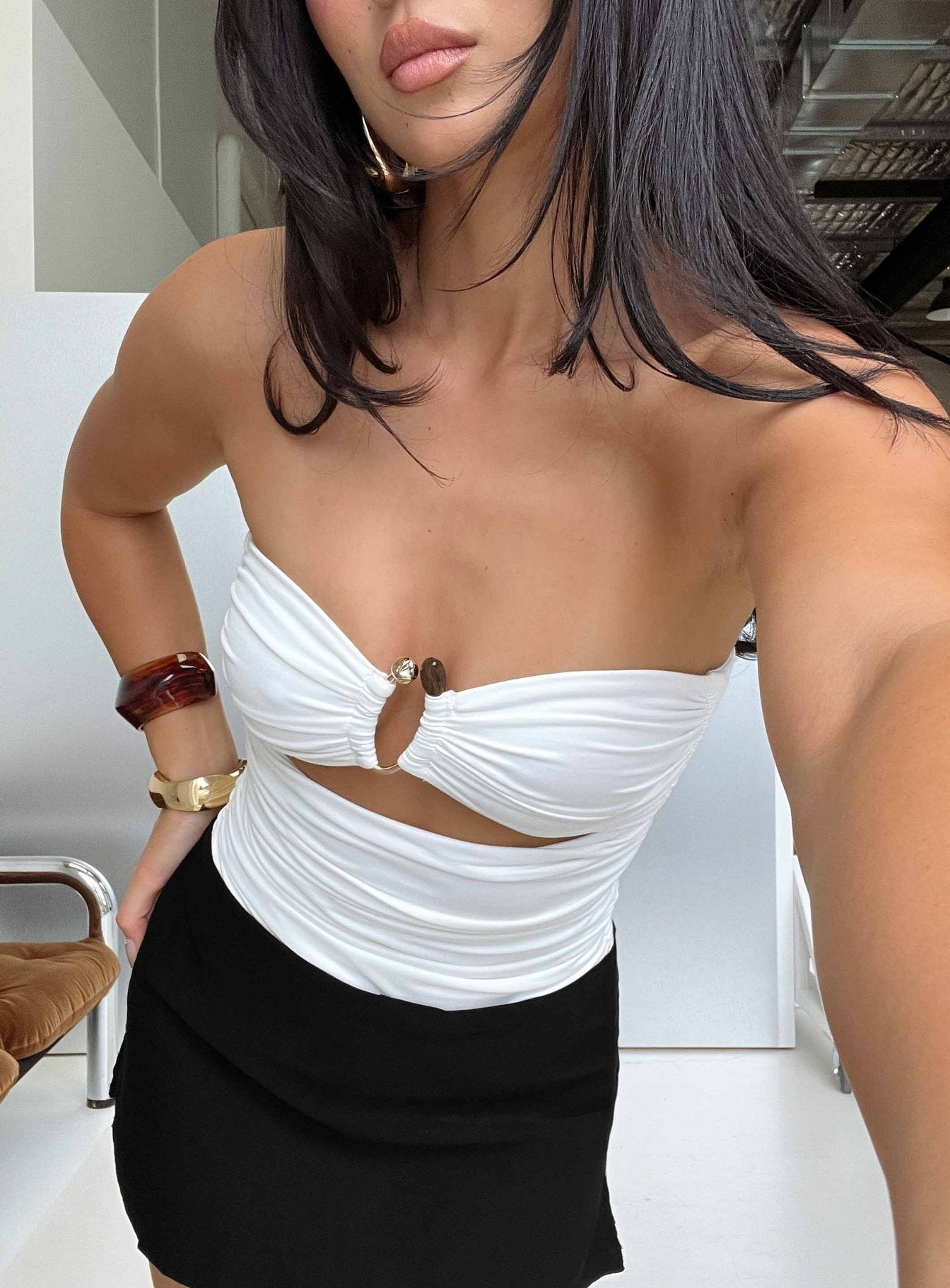 Showcasing the See Me Soon Strapless Hardware Detail Bodysuit White in sleeveless design front view of model wearing Princess Polly