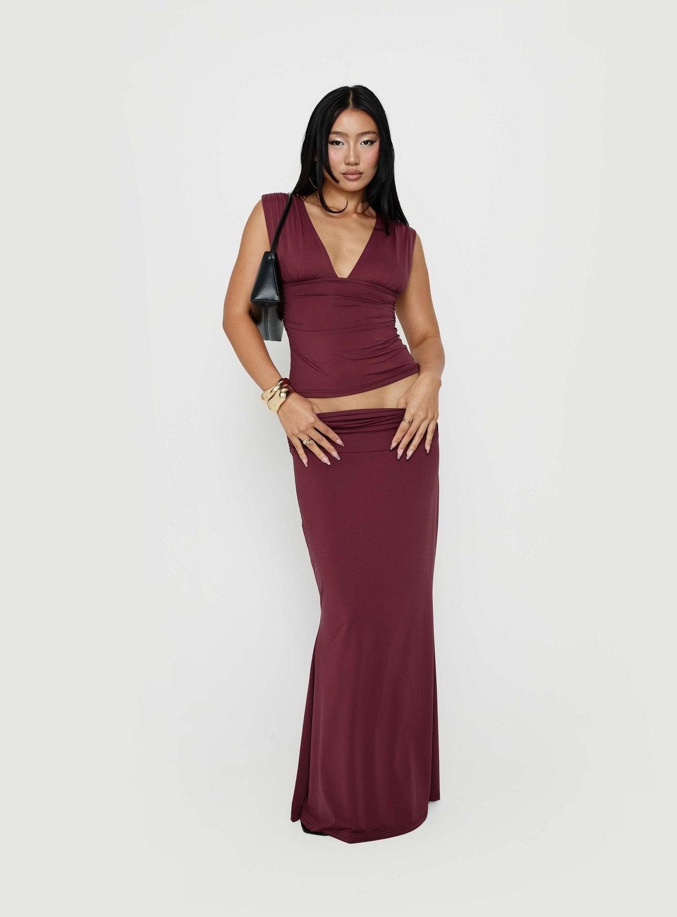Showcasing the Liorah Foldover Waist Maxi Skirt Red in womens-skirts with a maxi length front view of model wearing Princess Polly