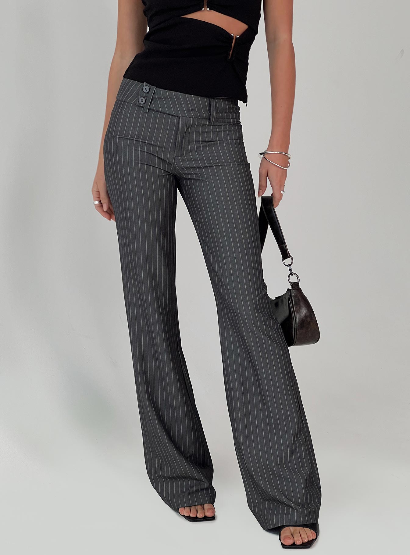 back view of model wearing Princess Polly Kinkirk Flared Pants Grey Pinstripe Petite 