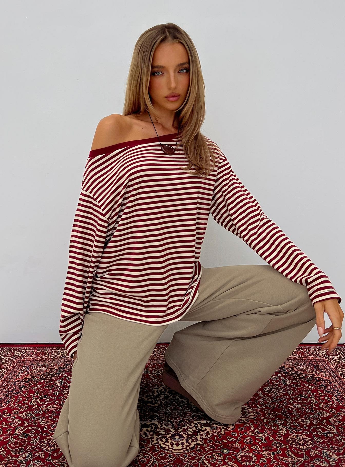 front view of model wearing Princess Polly Ralyssa Off Shoulder Long Sleeve Top Red Stripe Longline Jumpers Jumpers 