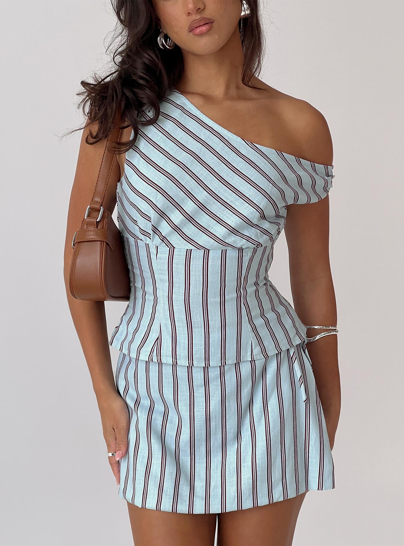 side view of model wearing Princess Polly Del Rio Off The Shoulder Top Blue / Maroon Short Sleeves Asymmetric Neckline 