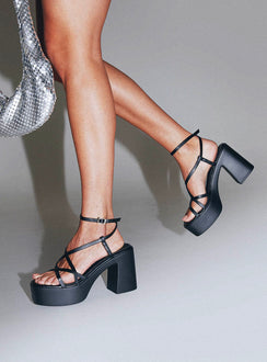 Heels Platform style, open toe, flared block heel Faux leather material, square open toe, thin upper straps Thin Ankle Strap with Adjustable Buckle Fastening