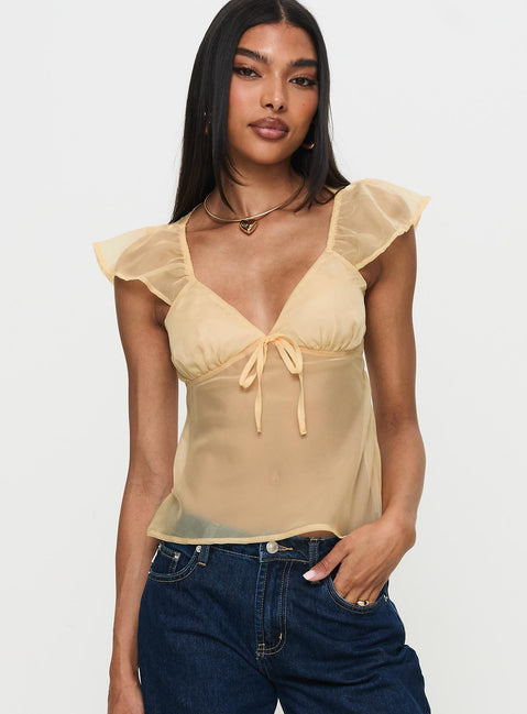 side view of model wearing Princess Polly Keysia Cap Sleeve Sheer Top Apricot Short Sleeves Plunger 