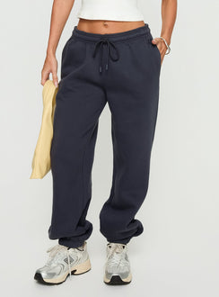 side view of model wearing Princess Polly Caspa Dream Fleece Oversized Ankle Cuff Jogger Navy High Rise Pants 