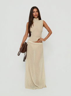 Crafted from premium fabric, the Ford Maxi Skirt Butter Chocolate Polka Dot in womens-skirts with a maxi length design side view of model wearing Princess Polly