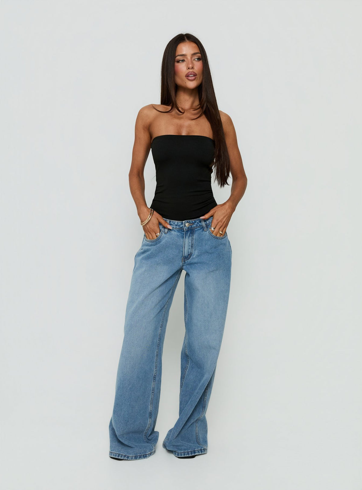 Showcasing the Namari Strapless Bodysuit Black womens-bodysuit with sleeveless and ruched details front view of model wearing Princess Polly