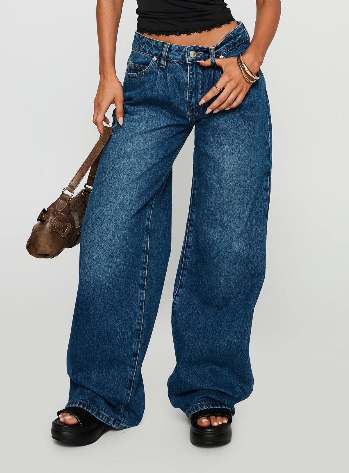 side view of model wearing Princess Polly Duster Oversized Jeans Dark Wash Mid Rise 