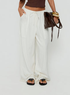 Highlighting the Peacemaker Tie Waist Relaxed Pants Off-White in womens regular pants with mid-rise detail view of model wearing Princess Polly