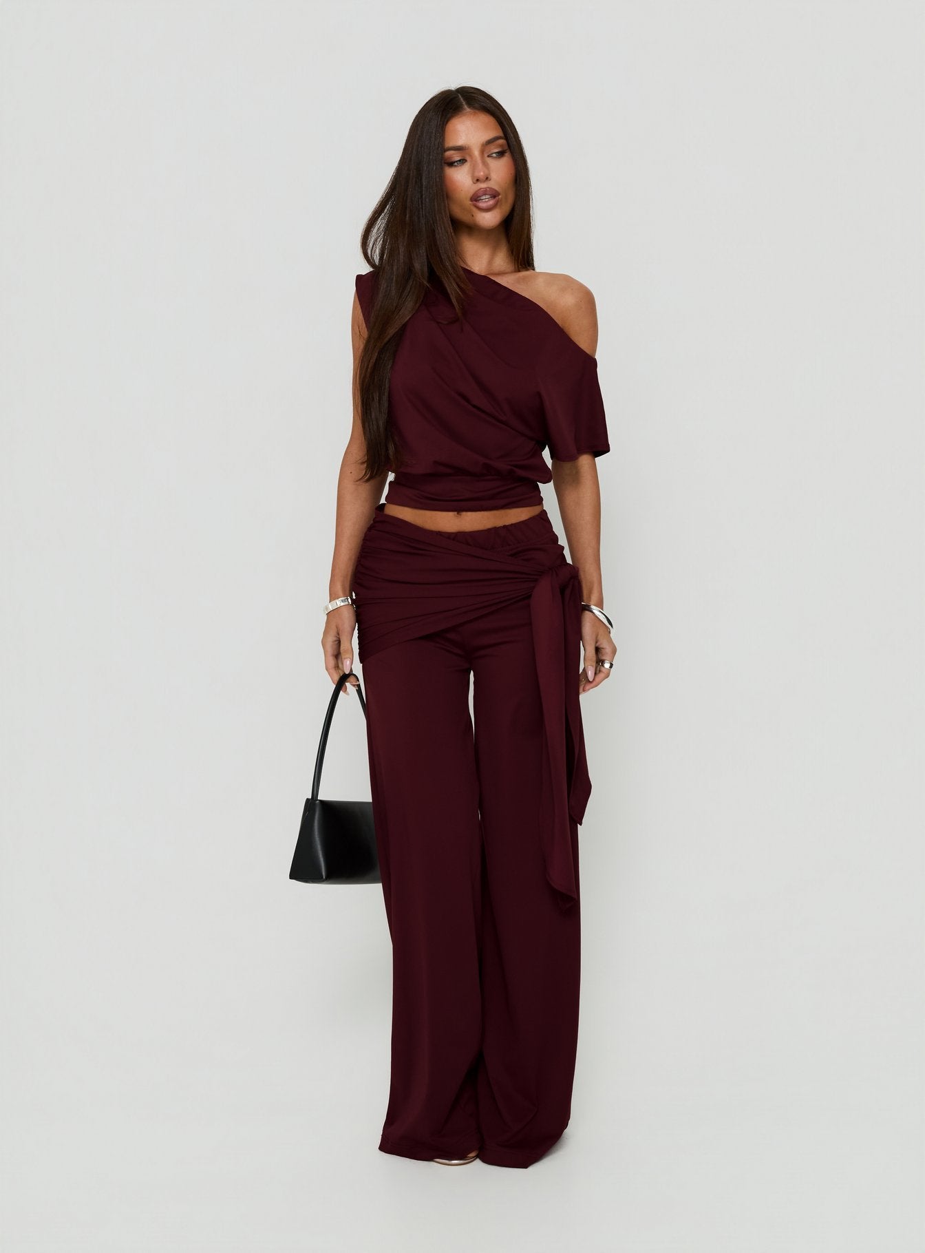 Showcasing the Hadlia Tie Waist Pants Burgundy womens-regular-pants with high-rise detail side view of model wearing
