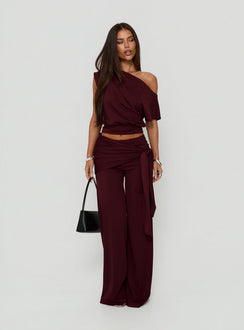 Showcasing the Hadlia Tie Waist Pants Burgundy womens-regular-pants with high-rise detail side view of model wearing
