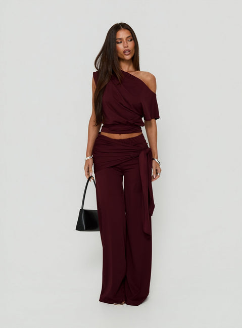 Showcasing the Hadlia Tie Waist Pants Burgundy womens-regular-pants with high-rise detail side view of model wearing