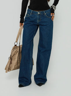Showcasing Tidal Wave Low Rise Straight Leg Jeans Dark Blue Wash in womens-jeans side view of model wearing Princess Polly