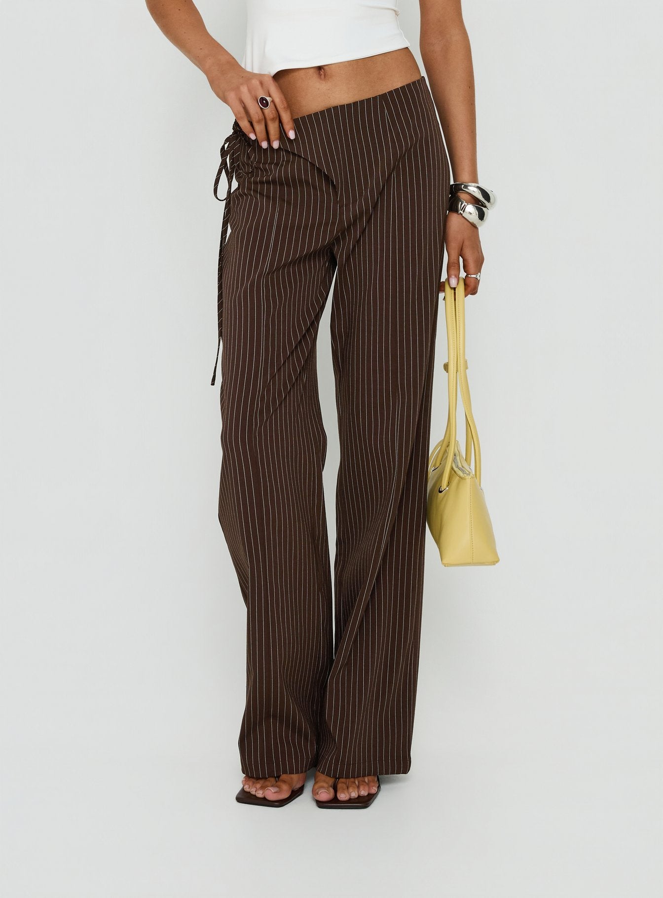 Designed with precision, the Editta Tie Detail Low Rise Tailored Pants Brown Pinstripe in womens-regular-pants with low-rise detail view of model wearing