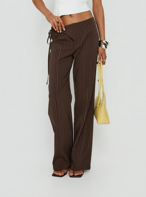 Designed with precision, the Editta Tie Detail Low Rise Tailored Pants Brown Pinstripe in womens-regular-pants with low-rise detail view of model wearing