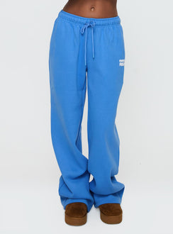 side view of model wearing Princess Polly Princess Polly Wide Leg Track Pant Bubble Text Blue High Rise Pants Pants 