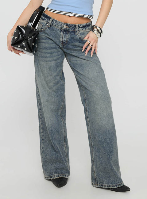 back view of model wearing Princess Polly Zaralyn Low Rise Wide Leg Jeans Mid Blue Wash Low Rise Jeans 