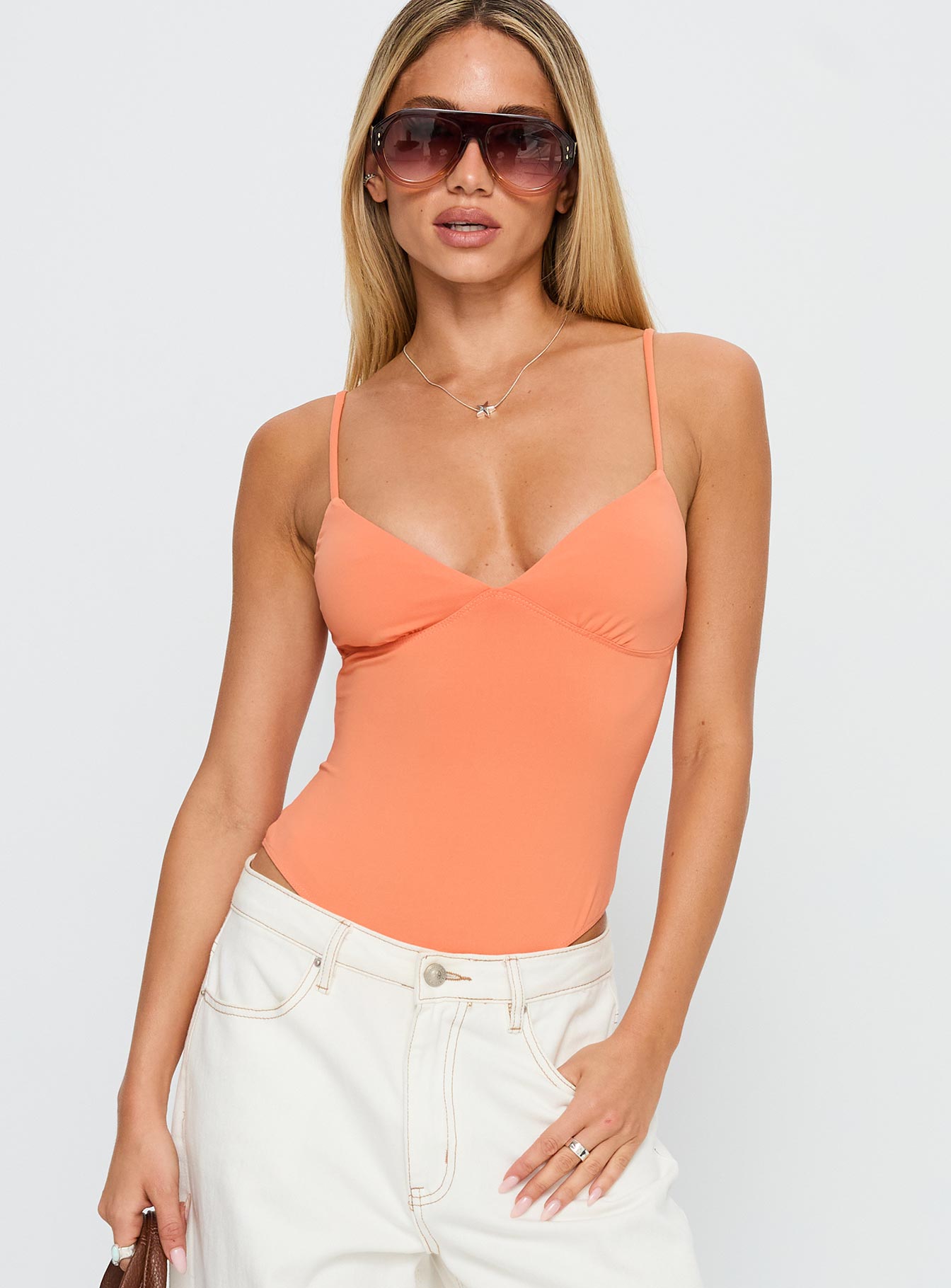front view of model wearing Princess Polly Slow Jams Bodysuit Orange Sleeveless 
