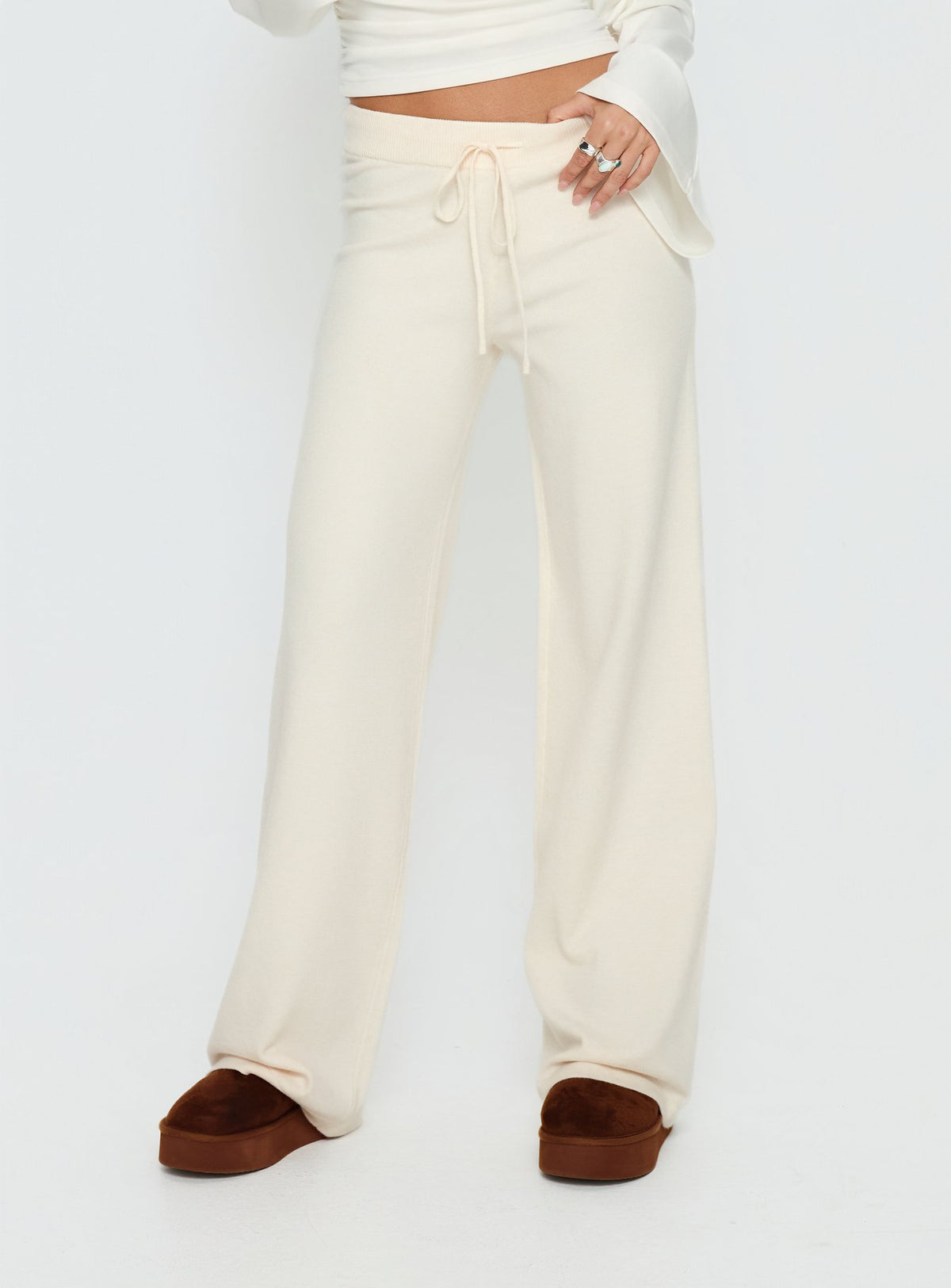 front view of model wearing Princess Polly Felisha Low Waist Knit Pants White Mid Rise Pants 