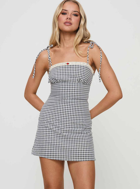 front view of model wearing Princess Polly Burkes Mini Dress Black Check Square Neck 