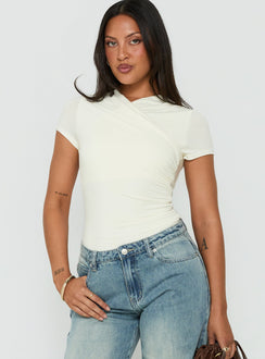 Discover the Odettea Cross Front Short Sleeve Bodysuit in Cream womens-bodysuit with short sleeves front view of model wearing Princess Polly