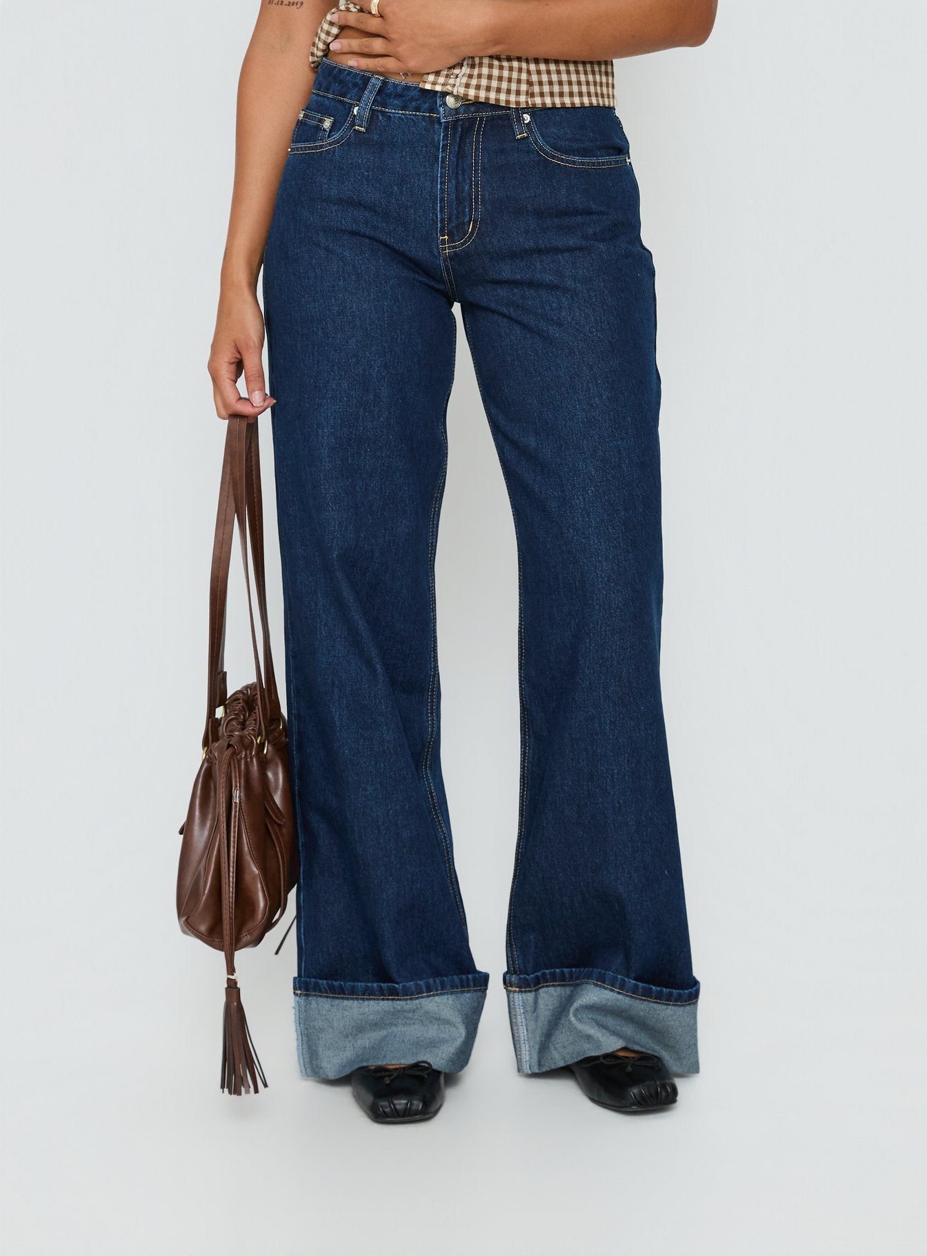 side view of model wearing Princess Polly Darla Low Rise Straight Leg Cuff Jean Dark Blue Wash Low Rise Jeans 