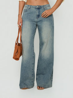 Featuring Karlos Low Rise Cinched Baggy Jeans Vintage Mid Blue Wash womens-jeans in low-rise front view of model wearing Princess Polly